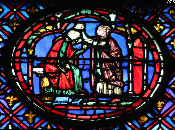 Seated man with woman stained glass scene at St Chapelle. Paris, France.