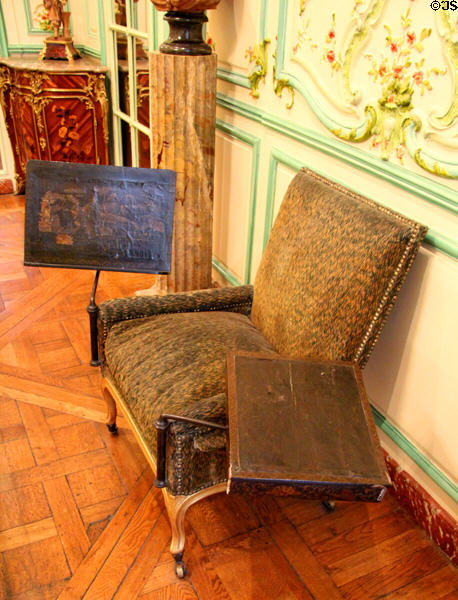 Armchair with reading & writing extensions in which Voltaire is believed by some to have died at Carnavalet Museum. Paris, France.