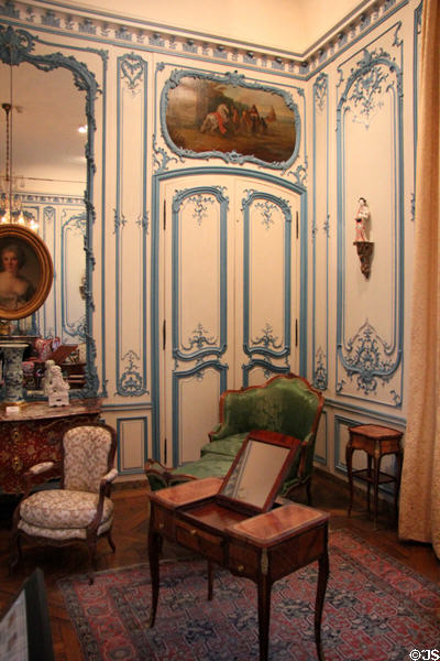 Ornate blue wall filigree from demolished mansion & period furniture in Blue Salon Louis XV at Carnavalet Museum. Paris, France.