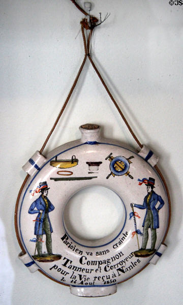Ceramic circular canteen (gourd) with ad for Companion Tanners (1850) by Faïence de l'Ouest from Nantes at Carnavalet Museum. Paris, France.