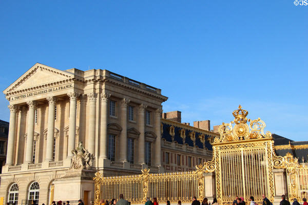 Southern Versailles Palace wing flanking Royal Court closed off by gilded gates. Versailles, France.