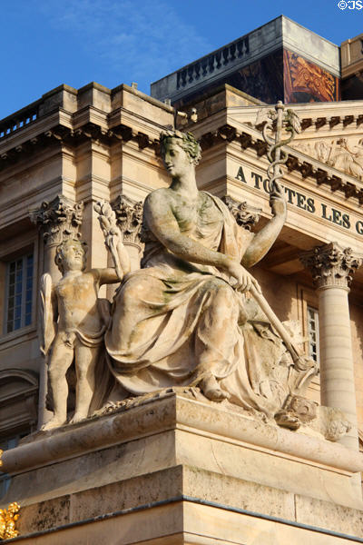 Northern Versailles Palace wing with caduceus figure statue. Versailles, France.