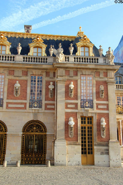 Busts of historic figures on facade of Marble Court at Versailles Palace. Versailles, France.