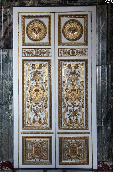 Elaborately carved doors in salon of abundance at Versailles Palace. Versailles, France.