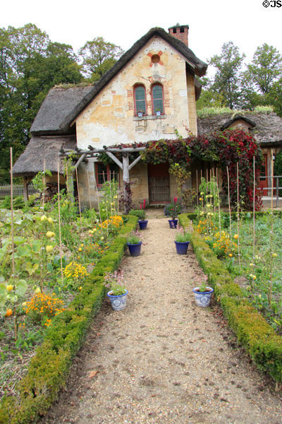 Garden path leading to Gardener's house at Marie Antoinette farm. Versailles, France.