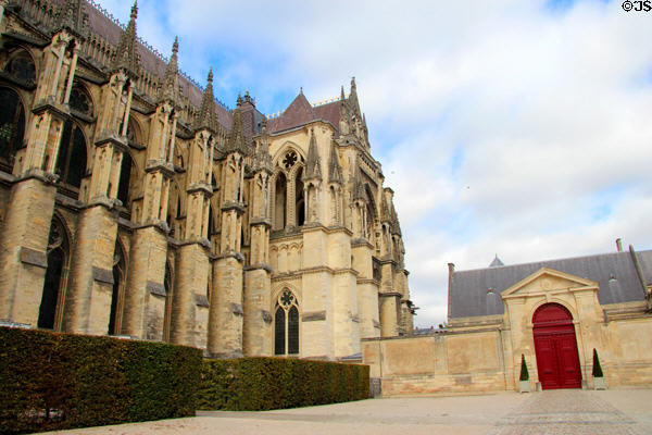 Side facade of Reims Cathedral beside Tau Palace. Reims, France.