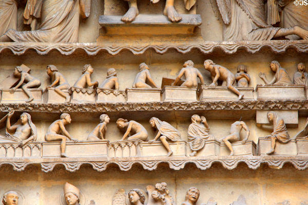Dead rising from tombs in Last Judgment scene on Reims Cathedral. Reims, France.