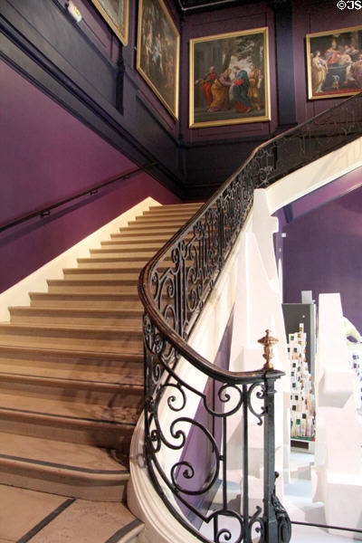 Staircase with curved wrought iron railing in Museum of Fine Arts. Reims, France.