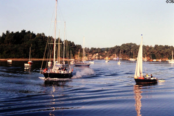 Sail boats enjoying cruising on deep blue waters. Gulf of Morbihan, France.