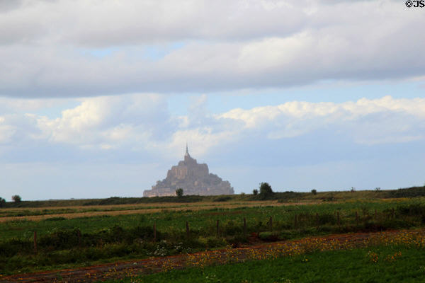 Mont-St-Michel seen at a distance across fields. Mont-St-Michel, France.