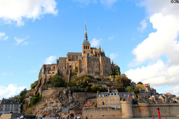 Mont-St-Michel abbey with town buildings & walls (1256) below. Mont-St-Michel, France.