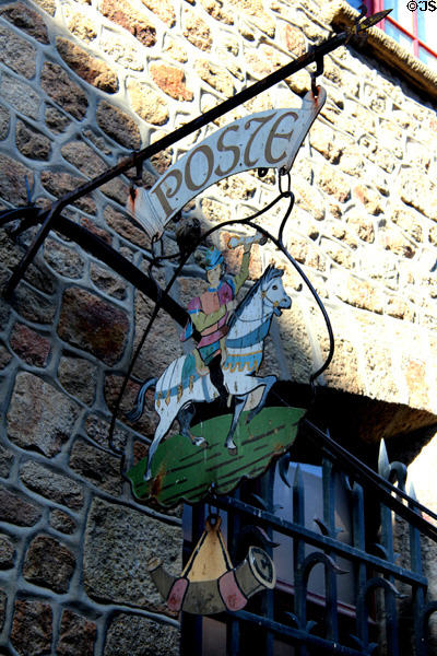 Ornate shop sign advertising postal service along Grande Rue. Mont-St-Michel, France.