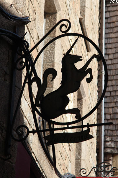 Sign with profile of unicorn along Grande Rue. Mont-St-Michel, France.