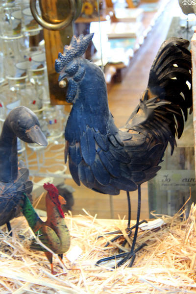 Artistic metallic roosters & duck in shop window along Grande Rue. Mont-St-Michel, France.