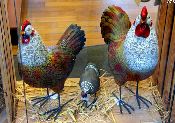 Artistic metallic chickens in shop window along Grande Rue. Mont-St-Michel, France.