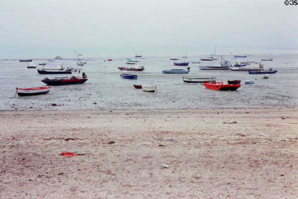 Fishing boat resting on sand at low tide at Cancale. Cancale, France.