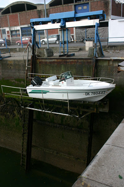 Boat being lowered into Dieppe harbor. Dieppe, France.