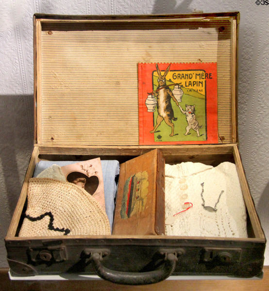 French child's evacuation suitcase & kit with ID bracelet at Caen Memorial. Caen, France.