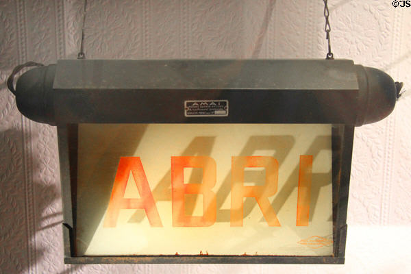 French illuminated air raid shelter sign (1939-44) at Caen Memorial. Caen, France.