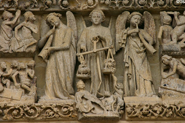 Angels weighing souls on Last Judgment carving of Amiens Cathedral. Amiens, France.