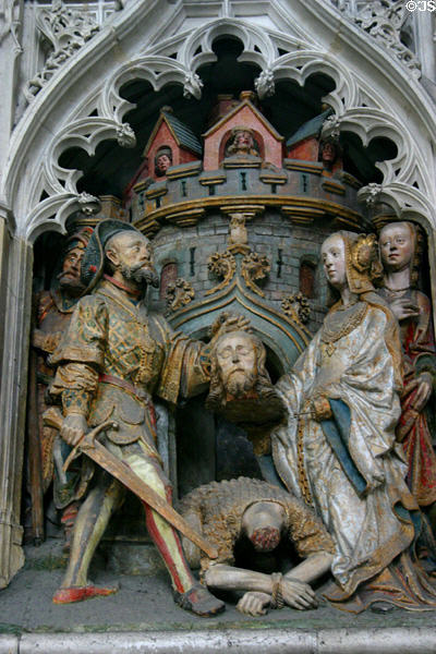 Depiction of beheading of John the Baptist with polychrome sculpted figures at Amiens Cathedral. Amiens, France.