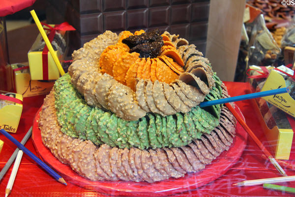 Colored baked specialty rounds with nuts at St Joan of Arc open-air marketplace. Rouen, France.