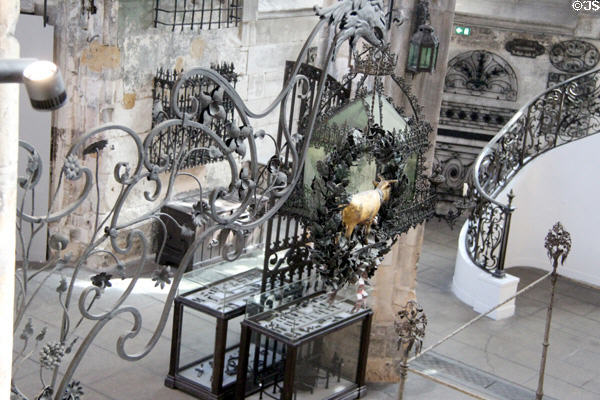 Giant iron griffin holding calf in wreath sign at Wrought Iron Museum. Rouen, France.