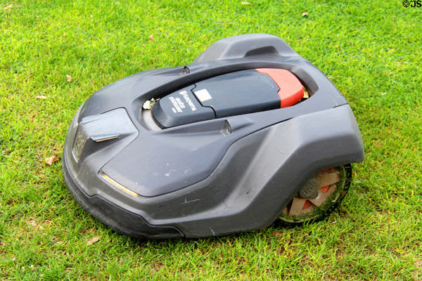 Robot lawn mower working on vast lawn of Naples Terrace at Chateau Royal of Amboise. Amboise, France.