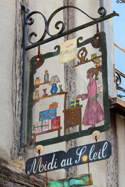 Ornamental wrought iron shop sign for Midi au Soleil. Amboise, France.