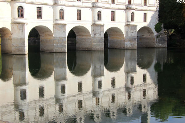 Chenonceau Chateau bridge reflected in River Cher. Chenonceau, France.