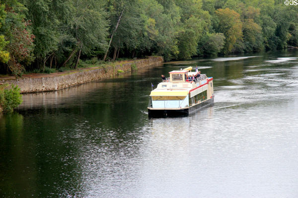Tour boat on Cher River approaching Chenonceau Chateau. Chenonceau, France.