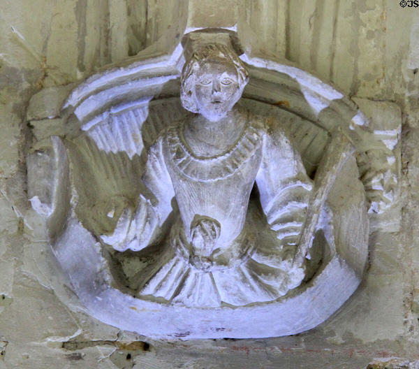 Man with mace carved on column base around cloister at Fontevraud Abbey. Fontevraud, France.