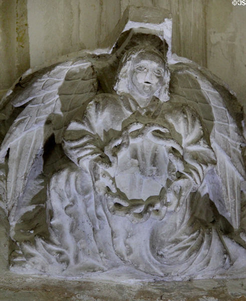 Man with ring of snakes carved on column base around cloister at Fontevraud Abbey. Fontevraud, France.