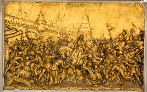 Detail of Joan of Arc entering Orleans in triumph on base of statue (1912) by André Vermare from Lyon at Orleans Cathedral. France.