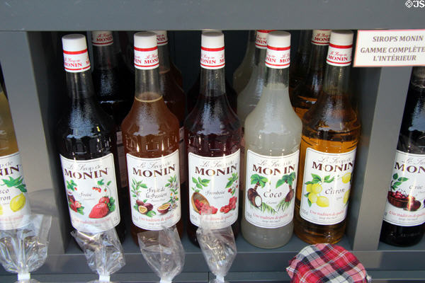 Fruit syrups in shop window on Place St Croix. France.