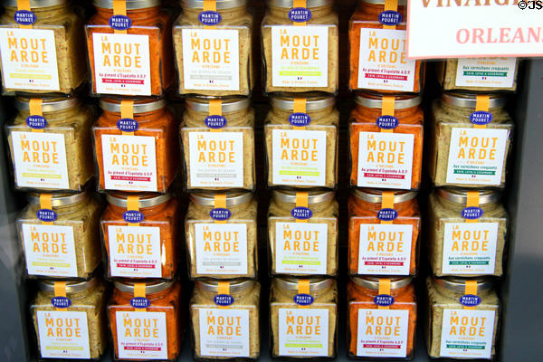 Flavored mustard jars in shop window on Place St Croix. France.