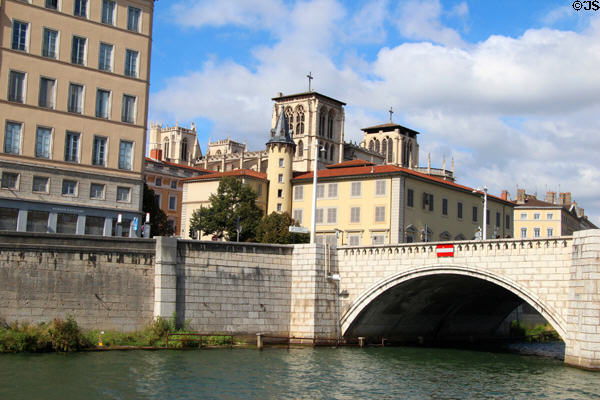 Square towers of Cathédrale Saint-Jean-Baptiste above Bonaparte bridge over Saône River. Lyon, France.
