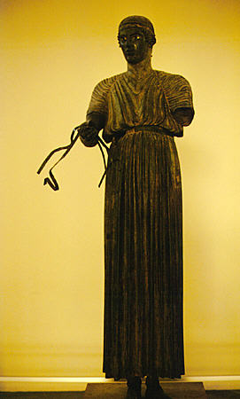 Bronze charioteer in Delphi Museum from approximately 478 BC was once connected to six horses. Greece.