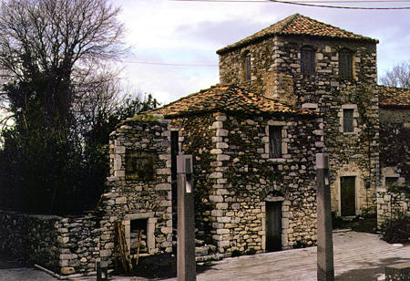 Stone houses on main square of Thalamas in Messiniakos Bay. Greece.