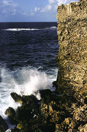 Waves crash against citadel in Methoni. Greece.