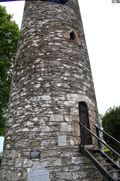 Doorway to round tower would normally be 15-20 feet above ground, but burials raised ground levels at Monasterboice. Ireland.