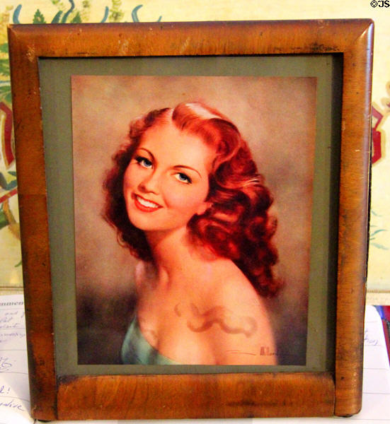 Disguised Paris Aerial radio behind glamour picture in frame designed for occupied France in hopes that German troops would be distracted by pinup & not look too closely at Hurdy Gurdy Museum of Vintage Radio. Howth, Ireland.