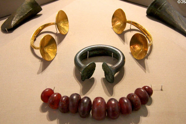 Hoard of bronze axeheads, gold dress fasteners, bronze bracelet & amber beads (c800-700 BCE) from Mountrivers at National Museum of Ireland Archaeology. Dublin, Ireland.