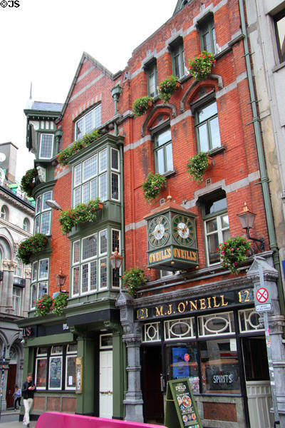 M.J. O'Neill pub with street clock on Suffolk Street facing Molly Malone statue. Dublin, Ireland.