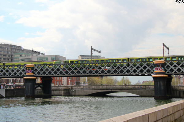 Commuter train on Loopline rail bridge over River Liffey. Dublin, Ireland.