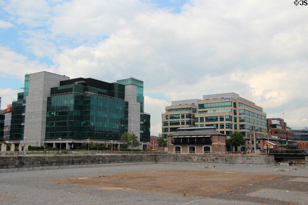 Modern office buildings built around ship turning basin off River Liffey at Custom House Basin. Dublin, Ireland.