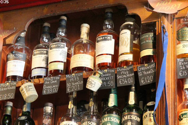 Premium Irish whiskey bottles lining shelves at Dick Mack's Pub in Dingle. Dingle, Ireland.