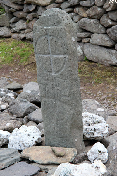 Ancient stone with cross at Gallarus Oratory on Dingle Peninsula. Ireland.