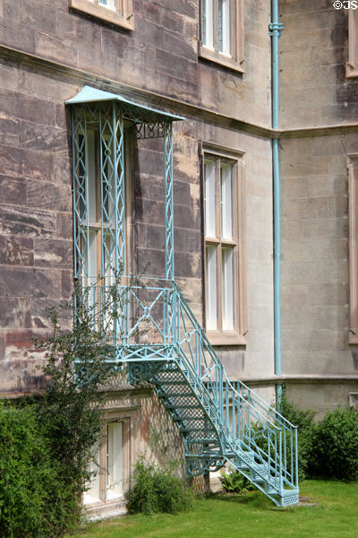 Ornate wrought iron steps to a back entrance of Muckross House in Killarney National Park. Killarney, Ireland.