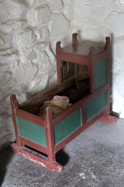 Young child's handmade cradle at Kissane's farm at Muckross Traditional Farms in Killarney National Park. Killarney, Ireland.